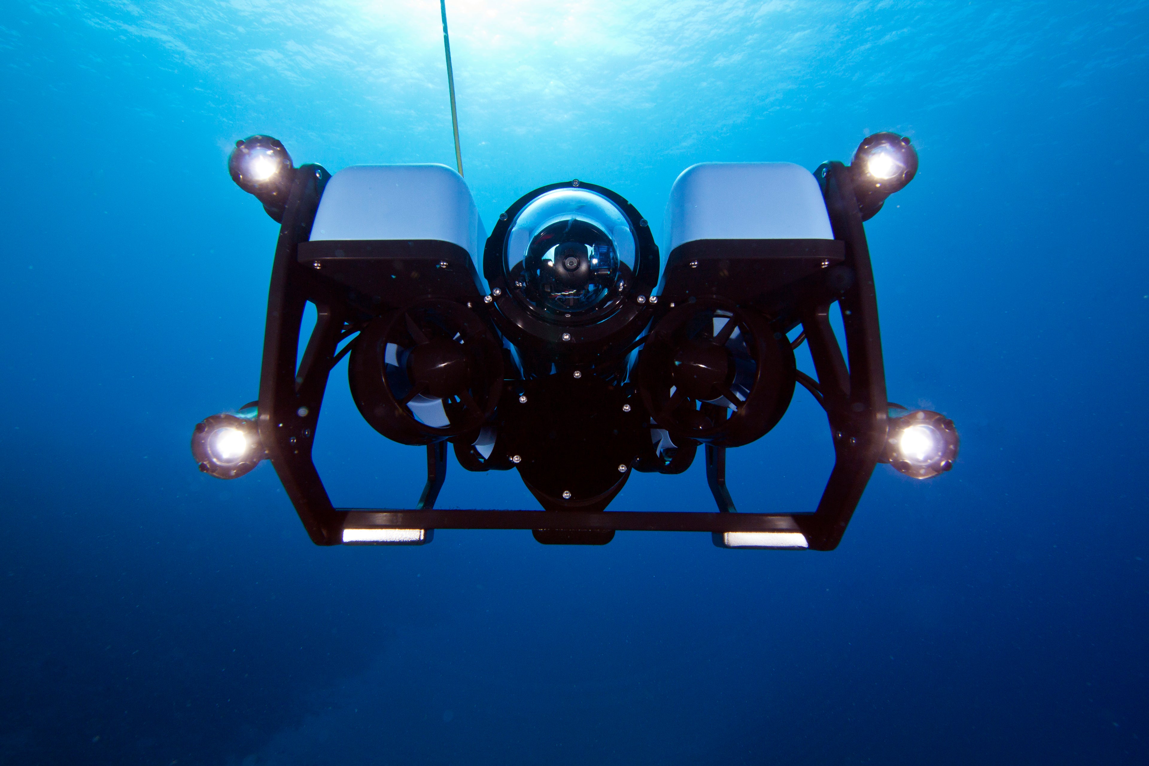 Underwater vehicle with lights on a blue underwater background